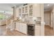 A butler's pantry featuring a wine cooler, granite countertops and glass front cabinets at 2446 Craven Dr., Myrtle Beach, SC 29572