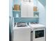 Bright laundry room with a front load washer, top load dryer, and storage shelves at 2446 Craven Dr., Myrtle Beach, SC 29572