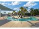Community lazy river with lounge chairs and palm trees for relaxation with a bridge at 2446 Craven Dr., Myrtle Beach, SC 29572