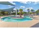 Community lazy river featuring calm, flowing water, lush palm trees, and comfortable lounge chairs at 2446 Craven Dr., Myrtle Beach, SC 29572