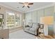 Cozy living room featuring a comfortable sofa, board and batten accent wall, and a large window for natural light at 2446 Craven Dr., Myrtle Beach, SC 29572