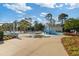 Community water park area featuring a splash pad, slides, and shaded lounge chairs for relaxation at 2446 Craven Dr., Myrtle Beach, SC 29572