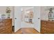 Bathroom view through a pair of open doors, showing double vanity and white marble flooring at 25 Northwoods Ct., Pawleys Island, SC 29585
