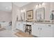 Bathroom featuring double sinks, granite countertop, white cabinets, and decorative framed mirror at 25 Northwoods Ct., Pawleys Island, SC 29585