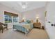 Well-lit bedroom with a cozy bed, woven window shades, and neutral decor at 25 Northwoods Ct., Pawleys Island, SC 29585