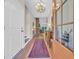 Elegant entryway featuring wood floors, a bright chandelier, and a clear view into the living area at 25 Northwoods Ct., Pawleys Island, SC 29585