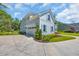 Charming home featuring a light blue exterior, light blue shutters and a curved driveway at 25 Northwoods Ct., Pawleys Island, SC 29585