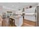 Modern kitchen featuring a granite island with seating, white cabinets, and stainless steel appliances at 25 Northwoods Ct., Pawleys Island, SC 29585