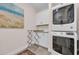 Well-appointed laundry room with stacked washer/dryer and utility sink at 25 Northwoods Ct., Pawleys Island, SC 29585