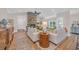 Spacious living room with brick fireplace, wood floors, and large windows for natural light at 25 Northwoods Ct., Pawleys Island, SC 29585