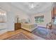 Spacious bedroom with tray ceiling, a king bed, two bedside lamps, and large windows at 25 Northwoods Ct., Pawleys Island, SC 29585