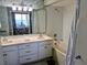 Bathroom with double sinks, spacious vanity, tub, and an ocean view through the Primary bedroom at 2507 S Ocean Blvd. S, North Myrtle Beach, SC 29582