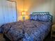 Comfortable bedroom featuring a patterned bedspread, a bedside table, and white closet at 2507 S Ocean Blvd. S, North Myrtle Beach, SC 29582