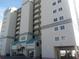 Stunning exterior view of a condo building with private balconies and covered parking at 2507 S Ocean Blvd. S, North Myrtle Beach, SC 29582