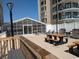 Outdoor picnic tables and grills on deck area, with pool visible in the background at 2507 S Ocean Blvd. S, North Myrtle Beach, SC 29582