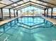 Indoor swimming pool with clear water, enclosed by glass walls and ceiling at 2507 S Ocean Blvd. S, North Myrtle Beach, SC 29582