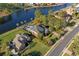 Aerial view of a luxurious waterfront home with a pool, lush landscaping, and private dock at 256 Shoreward Dr., Myrtle Beach, SC 29579