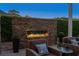 Cozy outdoor fireplace with comfortable seating, creating a relaxing outdoor living space at 256 Shoreward Dr., Myrtle Beach, SC 29579