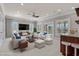 Bright living room with comfortable white furniture and views to the outside porch and water at 256 Shoreward Dr., Myrtle Beach, SC 29579