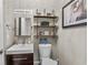 Stylish powder room boasting modern fixtures, vanity, decorative shelves, and artwork at 256 Shoreward Dr., Myrtle Beach, SC 29579