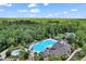 Aerial view of large community pool, clubhouse, mature trees, and surrounding community at 2600 Henagan Ln., Myrtle Beach, SC 29588