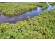 Aerial view showcases a river flowing through a forest with boats sailing on the water at 2600 Henagan Ln., Myrtle Beach, SC 29588