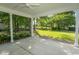 Covered back porch with concrete floor offers lovely view of the lush, green lawn and mature trees at 2600 Henagan Ln., Myrtle Beach, SC 29588