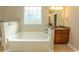 Bright bathroom featuring a large soaking tub and vanity with granite countertop and wood cabinets at 2600 Henagan Ln., Myrtle Beach, SC 29588