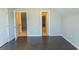Spacious bedroom with sleek wood flooring and a view through a doorway to a staircase at 2600 Henagan Ln., Myrtle Beach, SC 29588