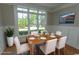 Staged dining room featuring a wood table with seating, a large window, and wainscoting, perfect for Gathering meals at 2600 Henagan Ln., Myrtle Beach, SC 29588