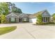 Traditional brick home with attached garage, dormers, and a large concrete driveway at 2600 Henagan Ln., Myrtle Beach, SC 29588
