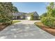 Beautiful brick home with large driveway, dormers, black shutters, and mature landscaping at 2600 Henagan Ln., Myrtle Beach, SC 29588