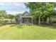 Charming brick home with well-manicured lawn, mature trees, and covered porch with ceiling fan at 2600 Henagan Ln., Myrtle Beach, SC 29588