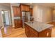 Beautiful kitchen island featuring granite counters, a stainless steel sink, and wood cabinetry at 2600 Henagan Ln., Myrtle Beach, SC 29588