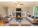 Staged living room with hardwood floors, a fireplace, and comfortable seating arrangement, showcasing a cozy space at 2600 Henagan Ln., Myrtle Beach, SC 29588