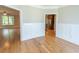 Open-concept living area with hardwood floors and white wainscoting leading to the kitchen at 2600 Henagan Ln., Myrtle Beach, SC 29588