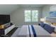 Staged bedroom with a cozy bed, television, and a sunny window at 2600 Henagan Ln., Myrtle Beach, SC 29588