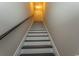 A long staircase leading upwards with white risers and dark wood treads at 2600 Henagan Ln., Myrtle Beach, SC 29588