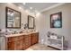 Bathroom with double vanities, decorative mirrors, neutral tile, and a marble countertop at 2767 Lees Landing Circle, Conway, SC 29526