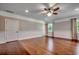 Bright bedroom with hardwood floors, white trim, a ceiling fan, and natural light from the windows at 2767 Lees Landing Circle, Conway, SC 29526
