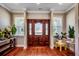 Inviting foyer with hardwood floors, stained-glass front door, side windows, and lush plants at 2767 Lees Landing Circle, Conway, SC 29526