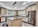 Bright and open kitchen featuring a center island, stainless steel refrigerator, and granite countertops at 2767 Lees Landing Circle, Conway, SC 29526