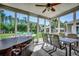 Relaxing sunroom with a dining table and chairs overlooking the backyard and a hot tub at 2767 Lees Landing Circle, Conway, SC 29526