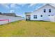Expansive fenced backyard, showcasing the home's exterior and providing ample space for recreation and activities at 302 Portofino Dr., Myrtle Beach, SC 29579