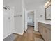 Bright bathroom with glass enclosed shower, wood look flooring, a vanity, and an open doorway to the bedroom at 302 Portofino Dr., Myrtle Beach, SC 29579
