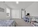 Bright bedroom features a ceiling fan, large closet, a window, and a desk, ideal for relaxing or studying at 302 Portofino Dr., Myrtle Beach, SC 29579