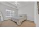 Serene bedroom with neutral tones, plush carpeting, and a large window providing ample natural light at 302 Portofino Dr., Myrtle Beach, SC 29579