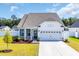 Charming one-story home with a two car garage, manicured lawn, and welcoming curb appeal at 302 Portofino Dr., Myrtle Beach, SC 29579