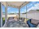 Relaxing screened porch with cozy seating, a turtle-themed rug, and backyard views for outdoor enjoyment at 302 Portofino Dr., Myrtle Beach, SC 29579