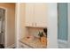 Convenient bar area with granite countertops, white cabinetry, and stylish decanters for entertaining guests at 304 San Martin Ct., Longs, SC 29568